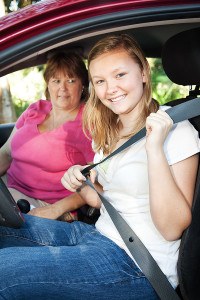 teen driver fastening seatbelt