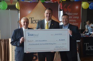 Joe Yurkovich (left), senior vice president of strategic planning and policyholder services at Texas Mutual; and Steve Math (right), senior vice president of underwriting at Texas Mutual; present a $5,234 check to Patrick Watkins, president of the Independent Insurance Agents of Texas.  