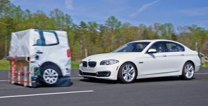 The BMW 5 series brakes for the target in an IIHS test. The car earns a superior rating when equipped with an optional camera and radar system. Photo: IIHS