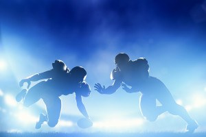 American football players in game, touchdown. Night stadium ligh