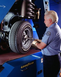 Tire test technician Terry Barrett makes some final adjustments to the Goodyer Fortera HL tire on the Flat Trac, a tire test that measures lateral force on a moving tire.  Photo: Goodyear