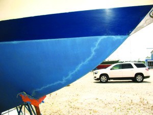 The jagged line in this sailboat’s hull paint is a "lightning track" that shows how the electrical charge passed from the bobstay to the jackstand to reach the ground. Photo: BoatUS