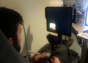 A subject watches a 4-minute video playing inside of an aperture moving around the perimetry of a video monitor while a camera records eye movements. Photo: NYU Langone Medical Center