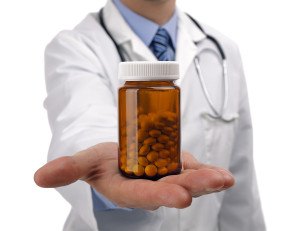 Doctor or pharmacist holding a bottle of pills