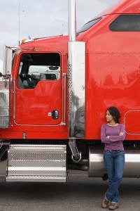 Young woman standing by her truck
