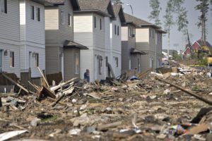 A resident of the Timberlea neighborhood looks over the damage of the area in Fort McMurray, Canada on June 2, 2016. Residents started to return to the fire-damaged city in northern Alberta, cleaning up their homes and property. (Jason Franson/The Canadian Press via AP) 