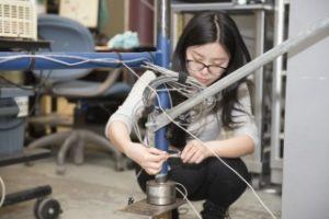 Xiao Yuan, architectural engineering Ph.D. candidate, connects and secures Cyber-Physical Systems (CPS) sensors on a temporary structure simulation in Engineering Unit A. Yuan's research focuses on the use of CPS to monitor and assess the safety of temporary structures used on construction sites. Photo: Penn State