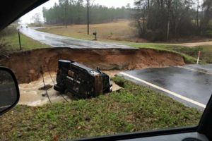 Louisiana flood washes out road and vehicle.Photo provided by state of Louisiana