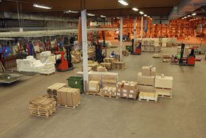 interior of warehouse with moving people, packages and parcels
